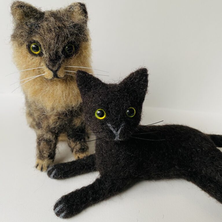 "Bastille and Cuke" (front view as pair), needle felted wool, glass, and nylon, 5 x 8 x 4 inches, 2021 (Private Collection)